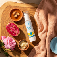 AFOULKI ingredients flatlay · argan kernels, magenta opuncija halved, creamy shea, pink rose petals