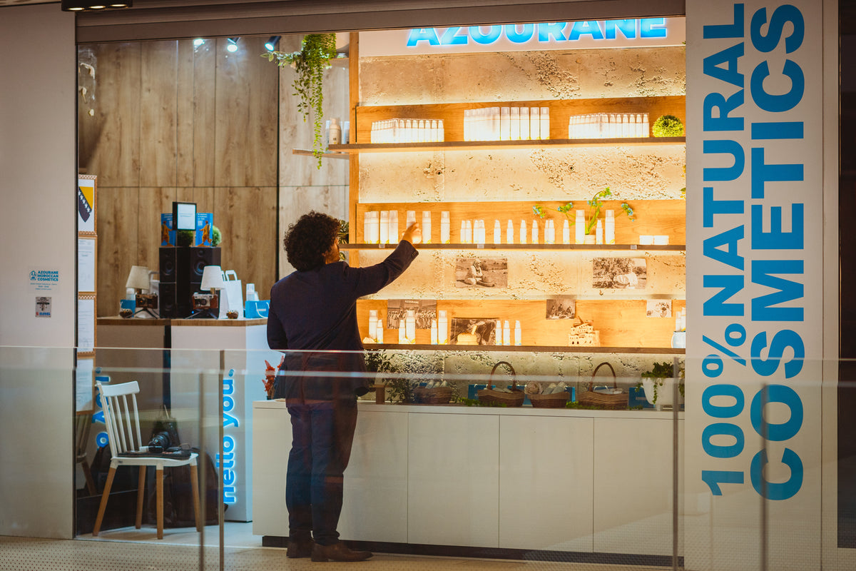 Hussam Aitelqadi, AZOURANE founder, seated with products in the store